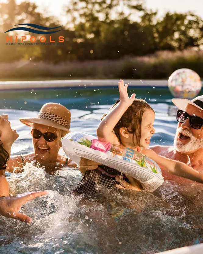 A family happily splashing around in their newly installed backyard swimming pool on a sunny day