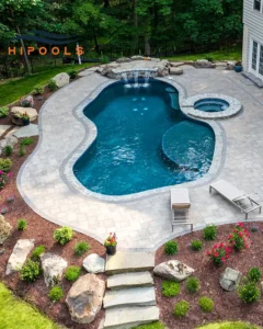 A luxurious custom-built swimming pool with waterfalls and landscaping, designed by top builders in Atlanta