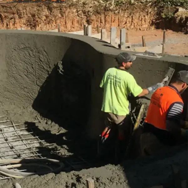A HiPools technician inspecting an existing in-ground pool