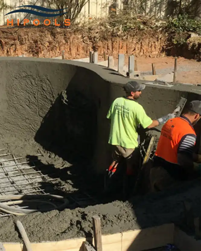 A HiPools technician inspecting an existing in-ground pool